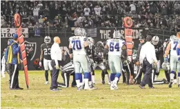  ?? KELLEY L. COX/USA TODAY SPORTS ?? The referees measure to determine that the Cowboys reached the first-down spot against the Raiders on Sunday.