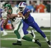  ?? SETH WENIG — THE ASSOCIATED PRESS ?? Jets quarterbac­k Aaron Rodgers is sacked by Bills defensive end Leonard Floyd during the first quarter on Monday in East Rutherford, N.J.