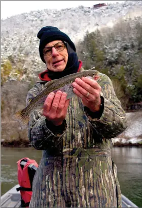  ?? (Arkansas Democrat-Gazette/Bryan Hendricks) ?? Richard Phelan of Little Rock caught about 20 rainbow trout like this one Jan. 16 while fishing with the author below snow-covered mountains on the White River.