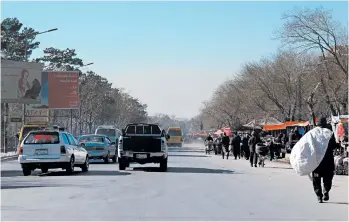  ?? ALEX HORTON/WASHIGNTON POST PHOTOS ?? A toxic haze has blanketed Kabul as cold air traps pollution caused by burning coal, wood and trash to stay warm.