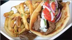  ??  ?? Gyro pitas are among the offerings at the Opa! stand.