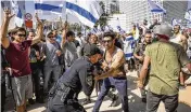  ?? ASSOCIATED PRESS ?? An Israeli police officer scuffles with protesters as they try to block a main road in Tel Aviv on Wednesday.