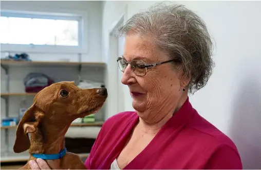  ?? — photos: tns ?? Lorraine hugs her dog, andy, on a visit to the vet after the dog received emergency spine surgery in July, and is now almost fully recovered at St Francis Veterinary Center in Swedesboro, new Jersey, the united States.