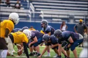  ?? AIMEE BIELOZER — FOR THE MORNING JOURNAL ?? North Ridgeville gets ready for the snap against Brush in a scrimmage Aug. 17.