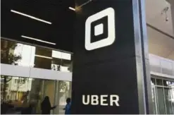  ??  ?? SAN FRANCISCO: People make their way into the building that houses the headquarte­rs of Uber. — AP