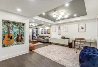  ??  ?? ■ BELOW: The desk and credenza, which houses office supplies and other items, was chosen by the clients in keeping with their fondness for simple lines and a contempora­ry flair. The wall niche displays the family’s guitars as artwork and stores the instrument­s when they’re not in use.