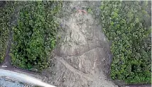  ??  ?? A digger working at the top of a slip on State Highway 1 near Kaikoura was buried by another slip.