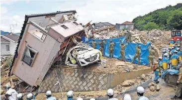  ?? [SADAYUKI GOTO/KYODO NEWS VIA THE ASSOCIATED PRESS] ?? Rescuers conduct a search operation for missing persons Monday in Kumano town, Hiroshima prefecture, western Japan.