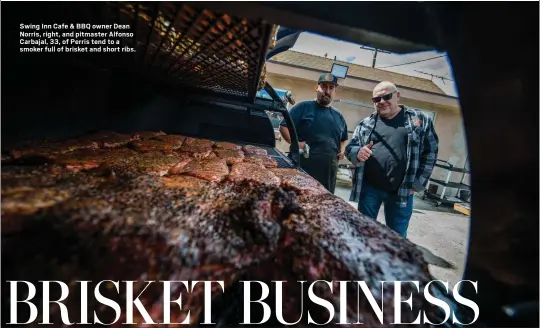  ?? ?? Swing Inn Cafe & BBQ owner Dean Norris, right, and pitmaster Alfonso Carbajal, 33, of Perris tend to a smoker full of brisket and short ribs.