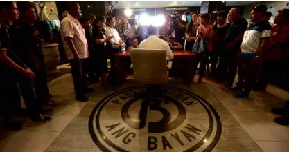  ?? JOANBONDOC ?? SITTING ONBINAY’S SEAL Acting Makati Mayor Romulo “Kid” Peña holds office at the entrance to the Makati City Hall on the ground floor, which is inlaid with the seal of Vice President Jejomar Binay when he was city mayor. The seal is ubiquitous in the...