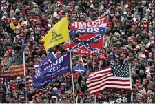  ?? EVAN VUCCI — THE ASSOCIATED PRESS FILE ?? FILE In this Wednesday, Jan. 6, 2021, file photo, supporters listen as President Donald Trump speaks as a Confederat­e-themed and other flags flutter in the wind during a rally in Washington.