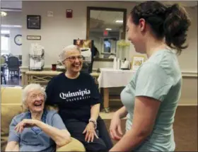  ?? PAT EATON-ROBB — THE ASSOCIATED PRESS ?? Cathleen Dacey, right, a Quinnipiac University law student, talks to Jeanne Piccirillo, 90, and Cairisse Miessau, 85, at Masonicare at Ashlar Village, a retirement community in Wallingfor­d, Conn. Dacey will live at the center this school year as part of an intergener­ational learning program.