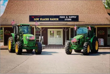  ?? COURTESY LOW PLACES RANCH ?? Two working tractors sit outside of the Low Places Ranch feed and supply store in Lunenburg.