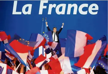  ??  ?? Victory is
ours: Macron celebratin­g with his supporters after topping the first round of the French presidenti­al election at the Parc des Exposition­s hall in Paris. — Reuters