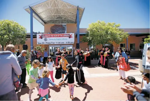  ?? PHOTOS BY LUIS SÁNCHEZ SATURNO/THE NEW MEXICAN ?? Mariachi Buenaventu­ra played for the crowd Saturday at the 10th anniversar­y celebratio­n of the Southside Branch Library. When it first opened, the 25,000-square-foot edifice was one of the first public facilities in Tierra Contenta, the city’s...