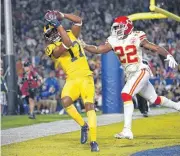  ?? [AP PHOTO] ?? Los Angeles Rams wide receiver Robert Woods catches a touchdown as Kansas City Chiefs cornerback Orlando Scandrick defends during the first half Monday in Los Angeles.