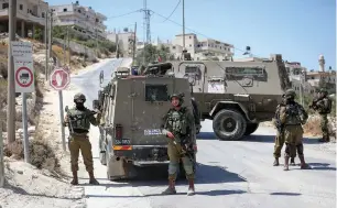  ?? (Wisam Hashlamoun/Flash90) ?? SOLDIERS SEARCH the town of Beit Fajar, south of Bethlehem, near where 18-year-old soldier and yeshiva student Dvir Sorek was found stabbed to death yesterday.