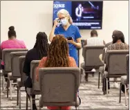  ?? IMPACT CHURCH—ASSOCIATED PRESS ?? In this photo provided by Impact Church, people wait for a Covid-19vaccinat­ion at an event held by Impact Church, Aug. 8, 2021, in Jacksonvil­le, Fla. The church has lost seven members to COVID-19IN the last few weeks, according to Pastor George Davis.