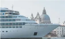  ?? Andrew Medichini, The Associated Press ?? A cruise ship transits in the Giudecca Canal in front of St. Mark’s Square in Venice, Italy. Venice is planning to divert the massive cruise liners.