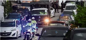  ?? — Bernama ?? Crowded road: Police outriders escorting the Black Maria away from Najib’s home in Taman Duta, Kuala Lumpur.