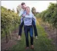  ?? JENN PRINE — PJ PAINTER VIA AP ?? PJ, top, and Ryan take a fun stroll through the grape vines of Atwood Hill Winery in Atwood, Ky., for an engagement photo.