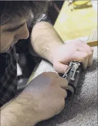  ?? Michael P. Farrell / Times Union archive ?? In this 2013 photo, Billy Cole cleans a clarinet at his shop in Saratoga Springs.