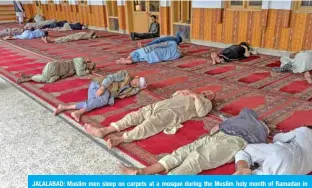  ?? AFP ?? JALALABAD: Muslim men sleep on carpets at a mosque during the Muslim holy month of Ramadan in Jalalabad.—