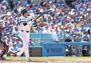  ?? KIYOSHI MIO/USA TODAY SPORTS ?? Dodgers designated hitter Shohei Ohtani follows through on a home run against the Braves on Sunday in Los Angeles. Ohtani hit two home runs on the Dodgers’ 5-1 victory.