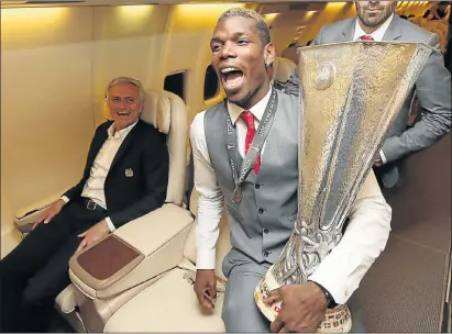  ?? Picture: GETTY IMAGES ?? HAPPY DAYS: Manchester United manager Jose Mourinho enjoys the moment as midfielder Paul Pogba shows off the Europa League trophy after their victory over Ajax in Stockholm on Wednesday