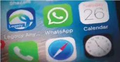  ??  ?? This photo illustrati­on shows the WhatsApp applicatio­n logo (C) on a smartphone screen in Beijing yesterday. Chinese authoritie­s appear to have severely disrupted the WhatsApp messaging app in the latest step to tighten censorship as they prepare for a...