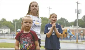  ?? AP photo ?? Hudson, 7 (from left), Callahan, 13 and Keegan Pruente, 10 stand outside their school on their first Monday home during the new four-day school week on Sept. 11 in Independen­ce, Mo.
