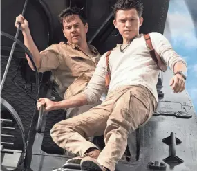  ?? CLAY ENOS ?? Victor “Sully” Sullivan (Mark Wahlberg, left) and Nathan Drake (Tom Holland) seek the lost gold of Magellan in “Uncharted.”