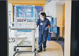  ?? K. C. Alfred San Diego Union- Tribune ?? ROSALINA BAEZ, who was vaccinated, cleans a room at Rady Children’s Hospital in San Diego. “Each person is equally important,” said one hospital director.