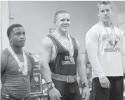  ?? JOE BURBANK/STAFF PHOTOGRAPH­ER ?? Park Vista’s Dustin Richter, center, bench pressed 430 pounds, the top bench press in Class 2A.