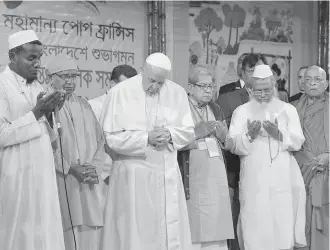  ??  ?? Pope Francis attends an interfaith and ecumenical meeting for peace in the garden of the archbishop's residence, in Dhaka, Bangladesh, on Friday.