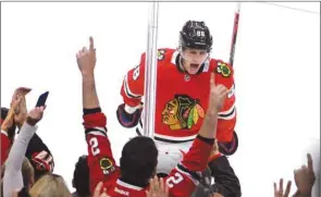  ?? (USA TODAY Sports) ?? Chicago Blackhawks’ Patrick Kane (centre) celebrates after scoring a goal against the Vancouver Canucks during the third period at United Center in Chicago, United States, on Thursday.