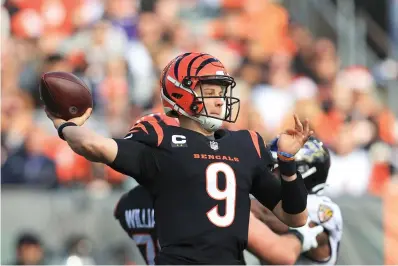  ?? AP Photo/Aaron Doster ?? Cincinnati Bengals quarterbac­k Joe Burrow (9) throws Dec. 26 during the first half of an NFL football game against the Baltimore Ravens in Cincinnati.