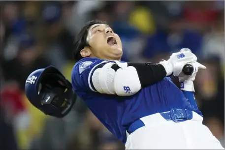  ?? JAE C. HONG — THE ASSOCIATED PRESS ?? Los Angeles Dodgers star Shohei Ohtani dodges a wild pitch by Los Angeles Angels starting pitcher Reid Detmers during the fifth inning of a spring training game Monday, March 25, 2024, in Los Angeles.