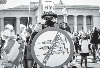  ?? LISA LEUTNER/AP ?? A man demonstrat­es against Austria’s looming coronaviru­s restrictio­ns Saturday in Vienna.