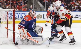  ?? Canadian Press photo ?? Calgary Flames' Matthew Tkachuk is stopped by Edmonton Oilers goalie Mikko Koskinen during third period NHL action in Edmonton on Sunday.