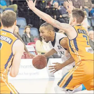  ?? CHRONICLE HERALD PHOTO ?? With a howl, Hurricanes’ centre Anthony Cox blows by Storm forward Brad States Tuesday night in National Basketball League of Canada playoff action in Halifax.
