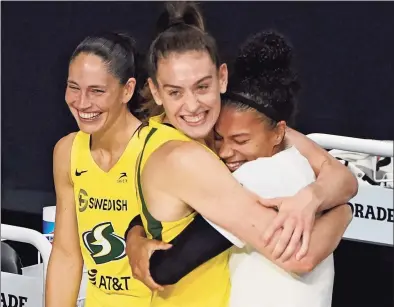  ?? Chris O’Meara / Associated Press ?? From left, the Seattle Storm’s Sue Bird, Breanna Stewart and Alysha Clark celebrate after the team defeated the Las Vegas Aces to win the WNBA Finals on Tuesday.