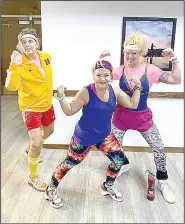  ??  ?? Joan Glubczynsk­i (from left), Lucy Quarti, and Jessica Anson, all part of the Property Owners Associatio­n Recreation Department, dressed up for a special-themed fitness class live-streamed last week from the Country Club boardroom in Bella Vista. (Courtesy photo)