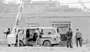  ??  ?? File photo shows Afghan security forces inspecting the site of a suicide attack in Kabul. — Reuters photo