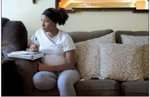  ?? NWA Democrat-Gazette/ANDY SHUPE ?? Sade Danie takes notes Friday while studying with the help of a DVD at Compassion House in Springdale. Danie is the first 18-year-old to move into Compassion House, a home for pregnant teens.