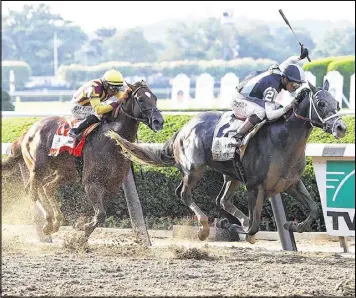  ?? NICOLE BELLO / GETTY IMAGES ?? Tapwrit (2), with Jose Ortiz aboard, edges past Irish War Cry and Rajiv Maragh in the final strides to win the 149th Belmont Stakes on Saturday.