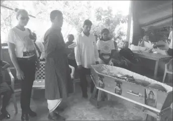  ??  ?? Babita Sarjou’s mother, Champa Seenarine (fourth from left) along with other relatives at the funeral proceeding­s.