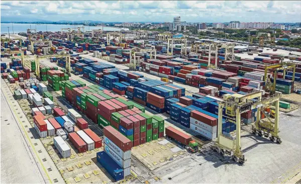  ??  ?? Strong performanc­e: Containers seen at North Butterwort­h Container Terminal. Malaysia’s exports rose to a record high of RM96.4bil in October after growing at a higher-than-expected rate of 17.7% from a year ago.