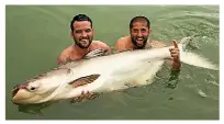  ??  ?? Ricky and Ali Hamidi in Thailand with a giant Mekong catfish.