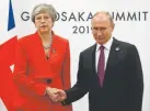  ?? The Associated Press ?? British Prime Minister Theresa May and Russian President Vladimir Putin shake hands during their meeting on the sidelines of the G20 summit.